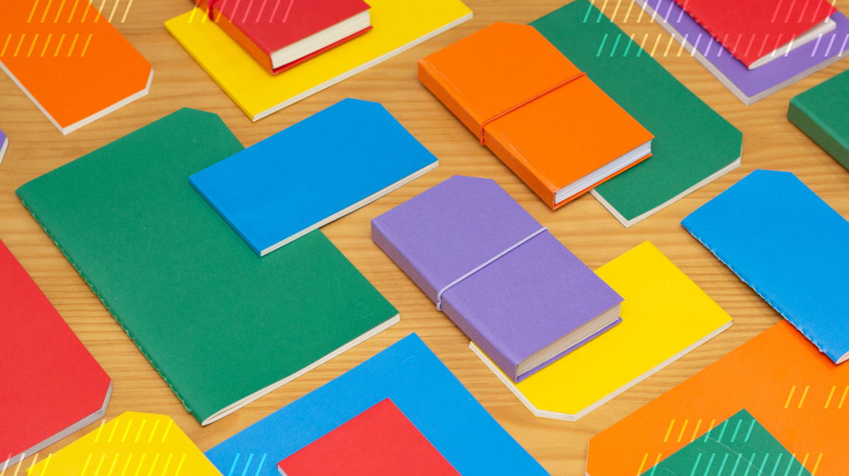 Colorful notebooks of different shapes and sizes arranged on a tabletop.